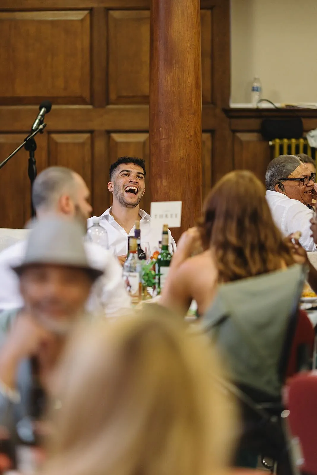 Laughing at a table during a wedding reception